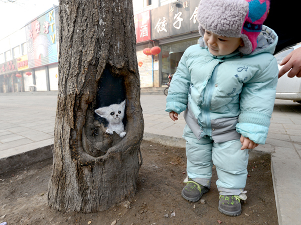 Tree hole art a treat for passers-by