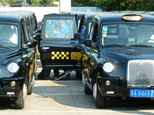 Classic British taxi cabs on road in E China