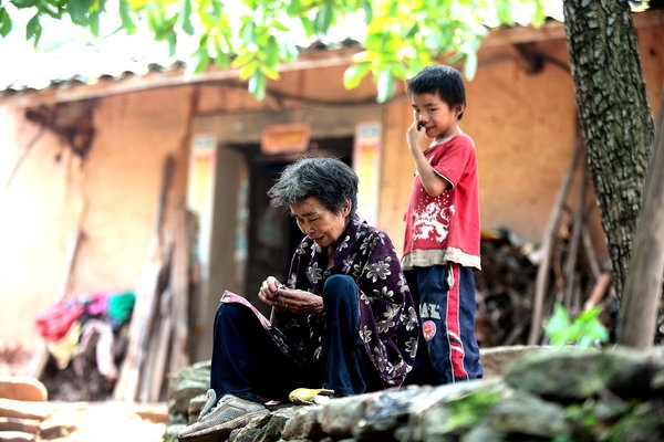 Boy, grandmother, live in isolation in SW China