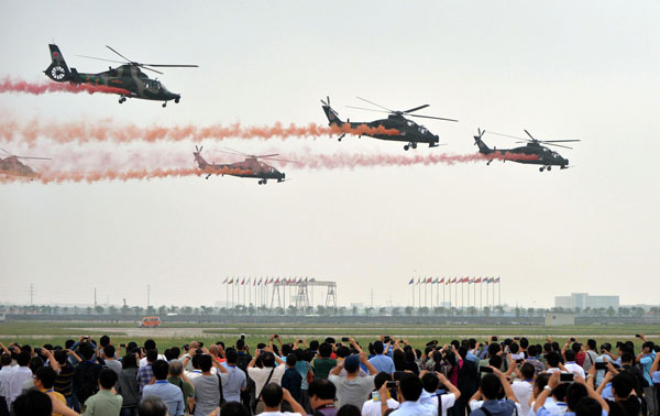 Helicopters practice acrobatic moves for expo