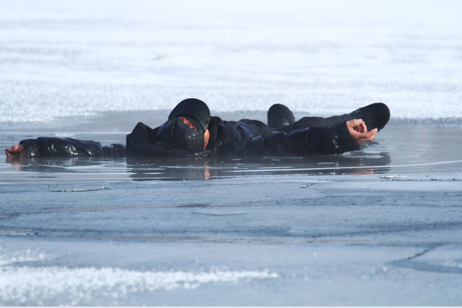Man saved after falling through frozen lake