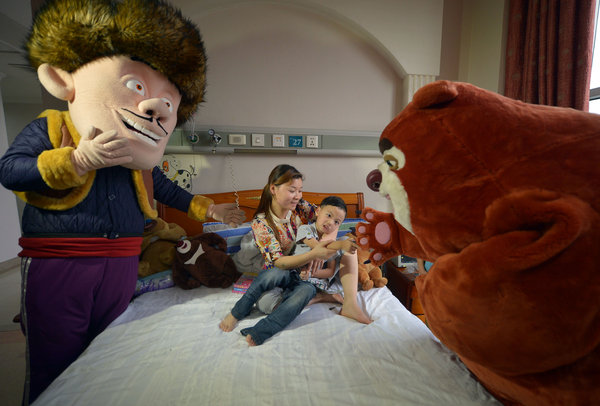 Cartoon characters visit brain tumor boy