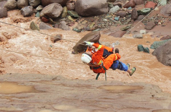 Rescuers pluck residents from raging torrent