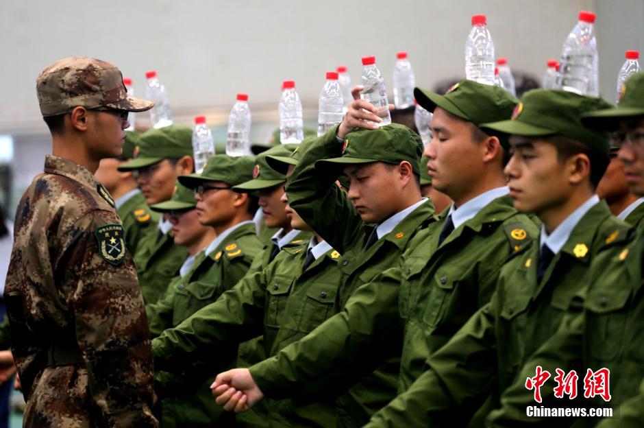 Military training with bottles balanced on heads