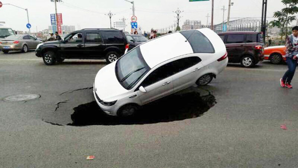 Car plunges into sinkhole