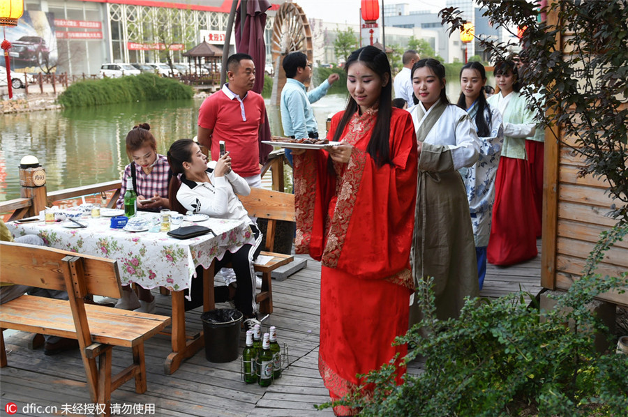 Restaurant employees serve history in traditional costumes