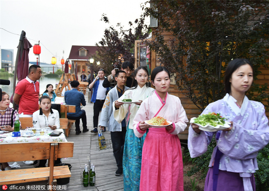 Restaurant employees serve history in traditional costumes