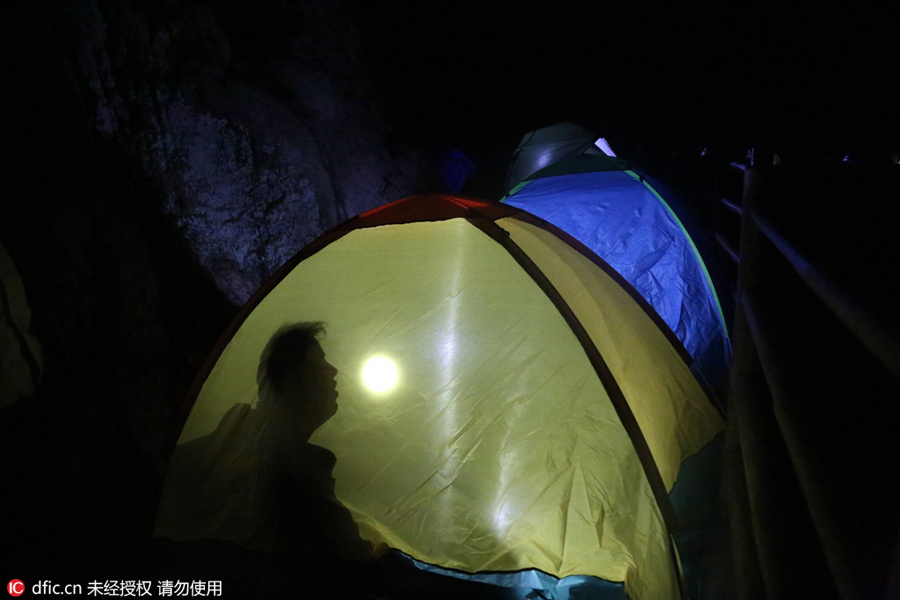 Campers sleep perched on cliff face