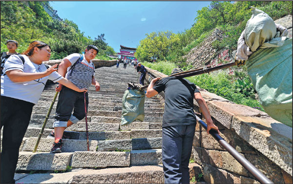 Porters see a steep drop on Taishan Mountain