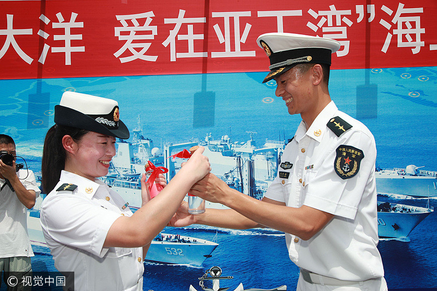 Navy sailors tie knot in middle of sea