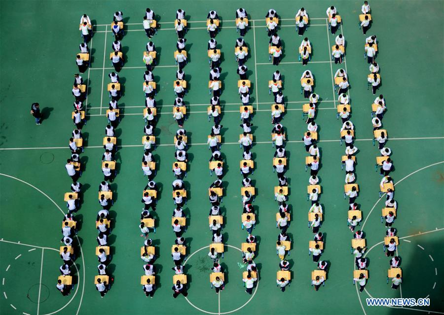 Pupils play Chinese chess during activity in NE China