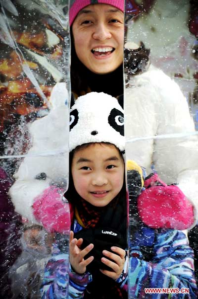 People enjoy ice sculptures in Harbin