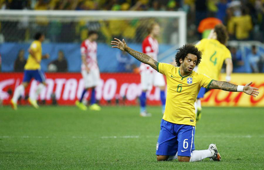Brazil survives own-goal to win World Cup opener