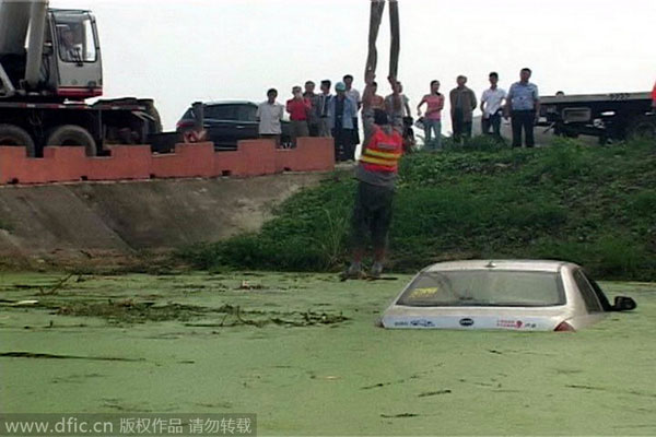 Calm driver waits on top of sinking car for help