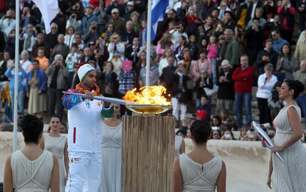Olympic flame handed over to Russian hosts