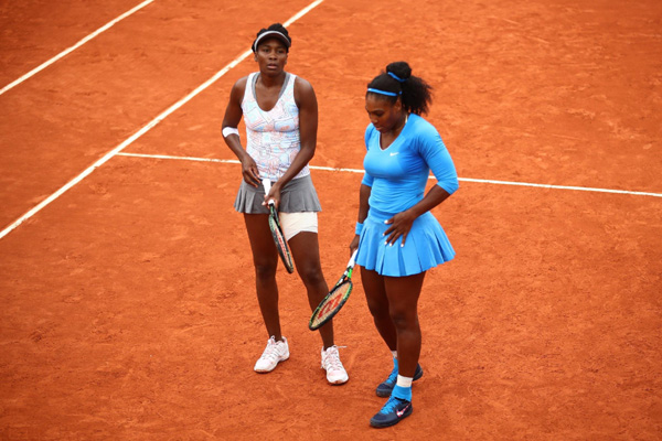 Williams sisters knocked out of doubles play at French Open