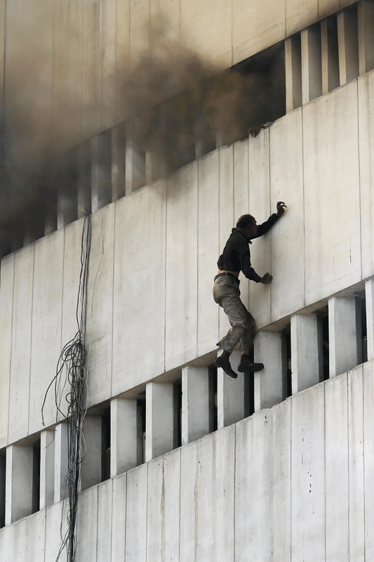 Men fall from building inferno