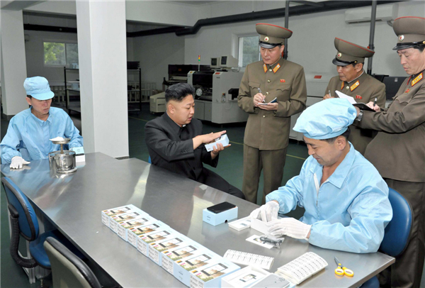 Kim Jong-un visits mobile phone factory