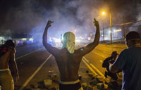 Gunfire heard as police scatter Missouri shooting protesters