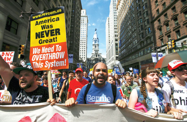 DNC leader quits amid e-mail leaks; thousands march for Sanders