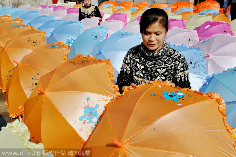 Women make umbrellas for export in Jiangxi