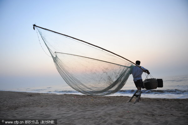 Fisherman stilted against power of the sea