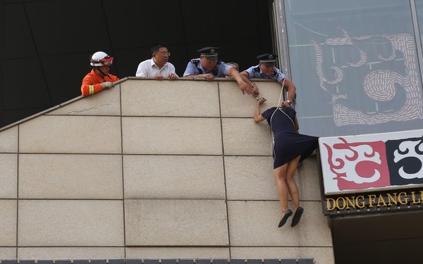 Woman pulled off the ledge in Beijing
