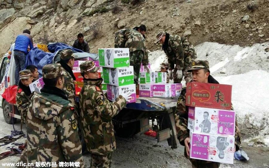 Rescuers deliver relief supplies on foot