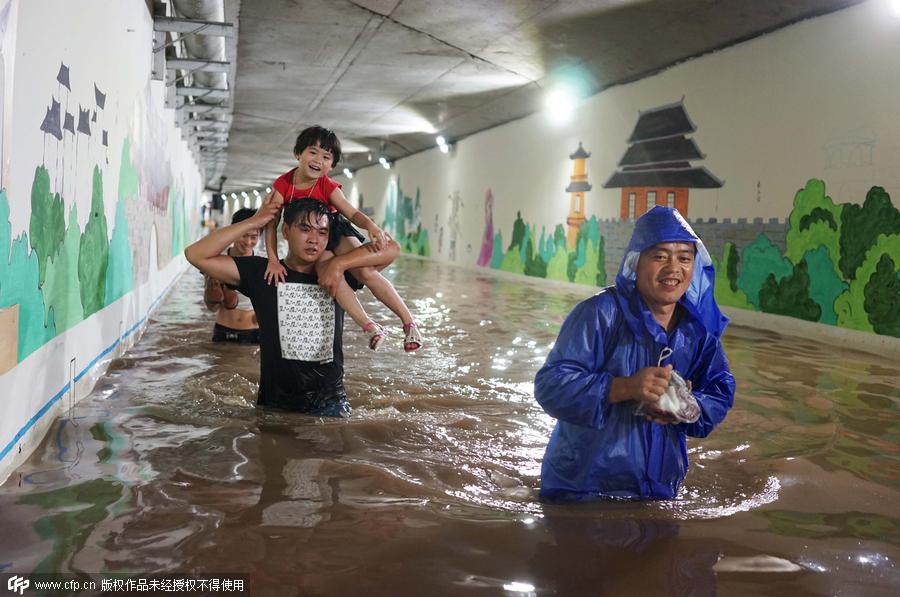 Family wades across flood to catch train