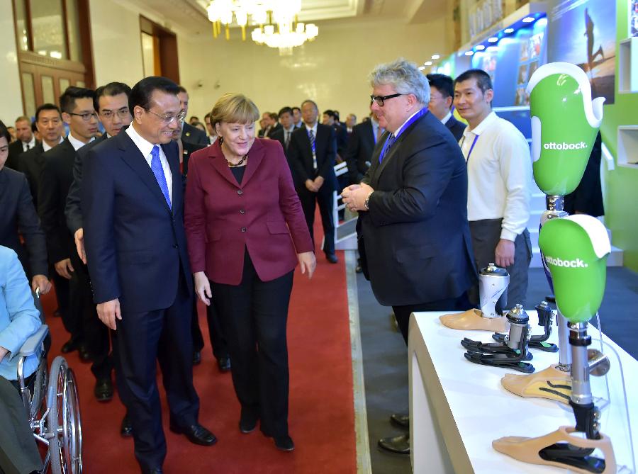 Li Keqiang, Merkel attend meeting on disability in Beijing