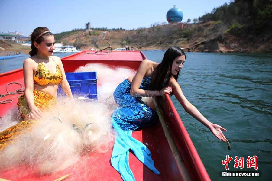 College students dressed in mermaid costumes to call for fishing halt
