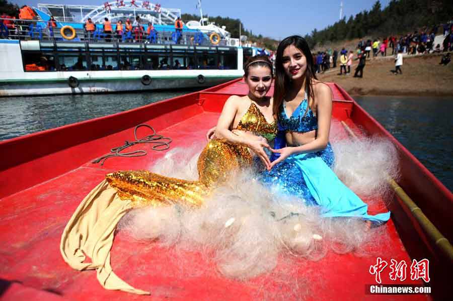College students dressed in mermaid costumes to call for fishing halt