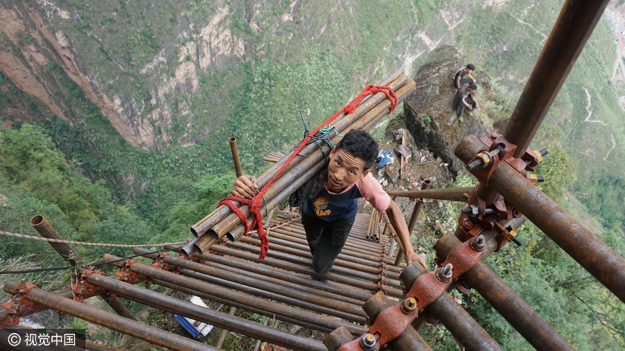 Villagers build ladder on cliff with 1,500 steel pipes