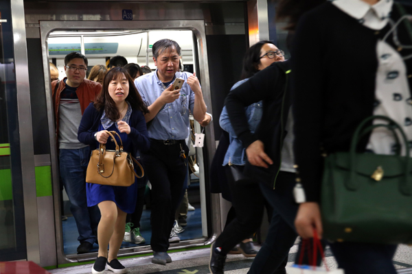 In Beijing, expansion, rising property prices lead to longer commutes