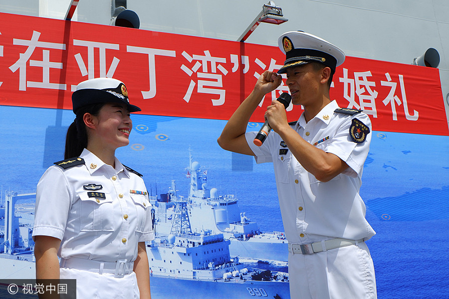 Navy sailors tie knot in middle of sea