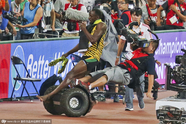 Bolt 'somersaults' after cameraman takes him down
