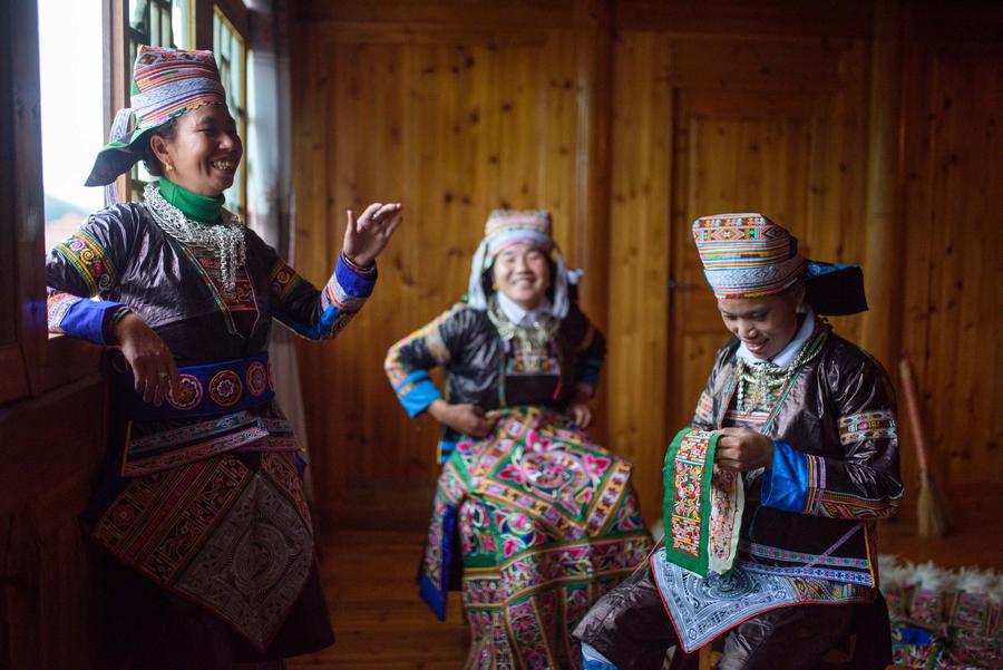 Villagers of Miao ethnic group make hundred-bird clothing
