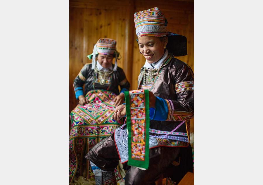 Villagers of Miao ethnic group make hundred-bird clothing