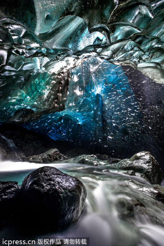 Amazing waterfall falls through ice caves