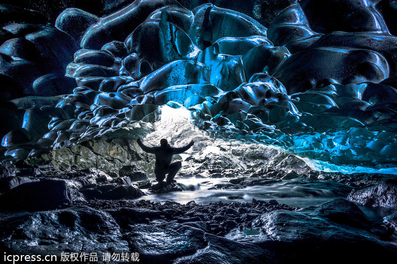 Amazing waterfall falls through ice caves
