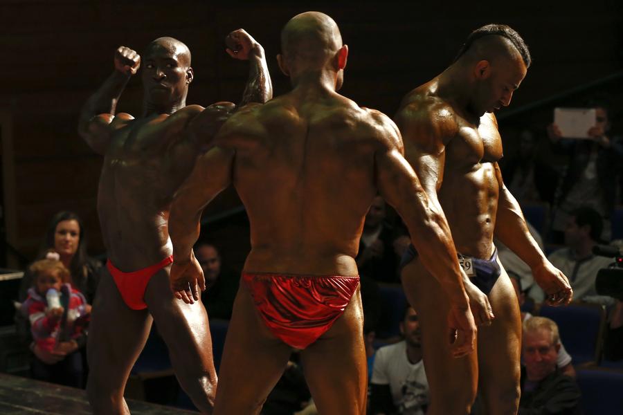 Bodybuilders prepare backstage before competition