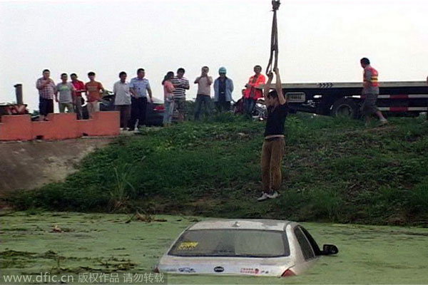 Calm driver waits on top of sinking car for help