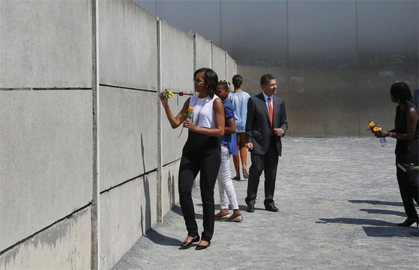 Michelle lays roses at site along Berlin Wall