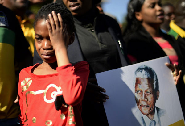 Mandela's condition 'improving' as Obama flies in
