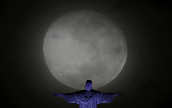 Big moon pictured with Christ the Redeemer statue