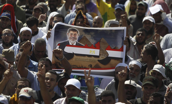 Morsi supporters defy police warnings to disperse