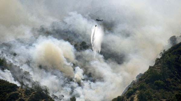 Fire rages through California park