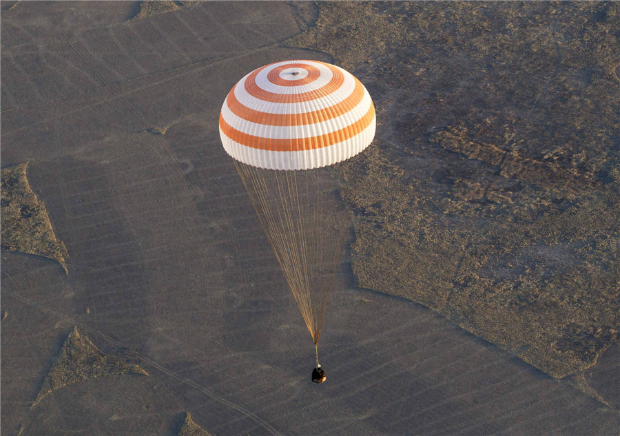 Intl space crew returns Olympic torch to Earth
