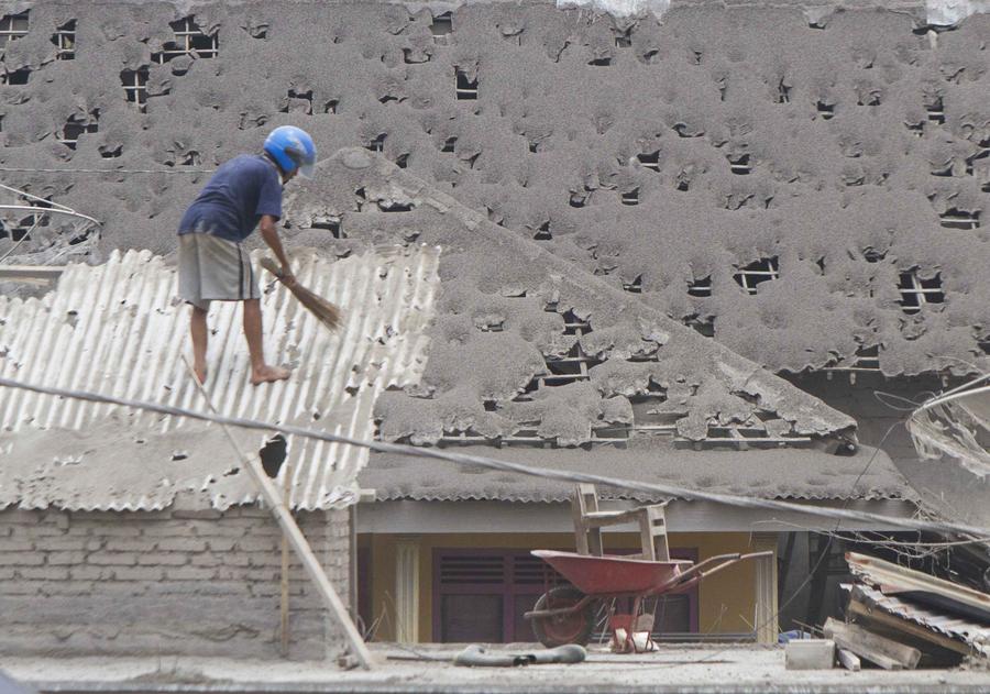 People clear volcano ash in Indonesia