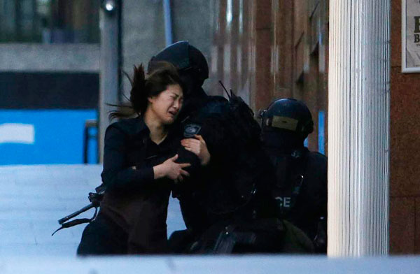 Police storm Sydney cafe to end hostage siege, three dead
